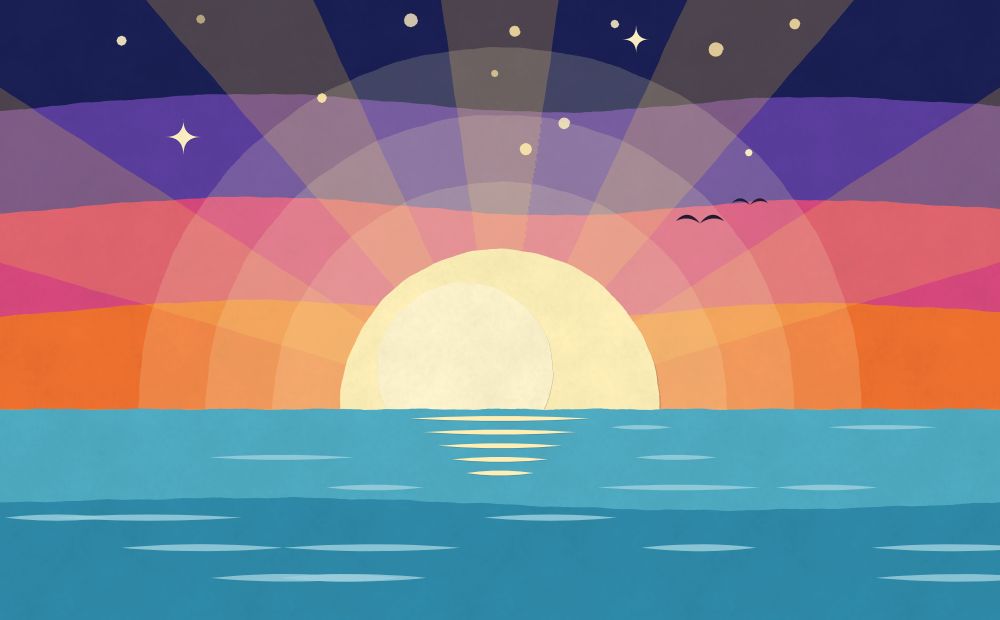 Paper cut-out of the sun rising over the sea